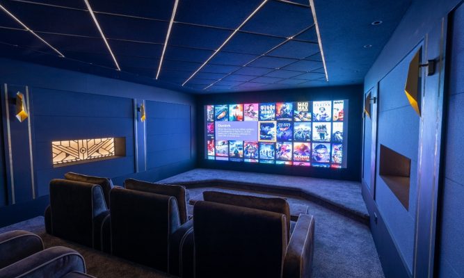 Cinema room with lights on the ceiling.